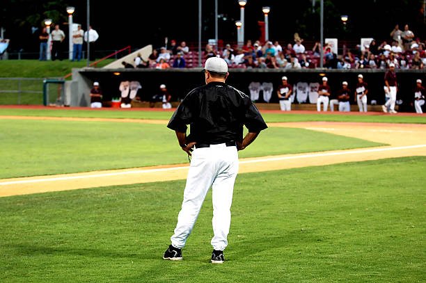 Baseball Manager coaching at third base.